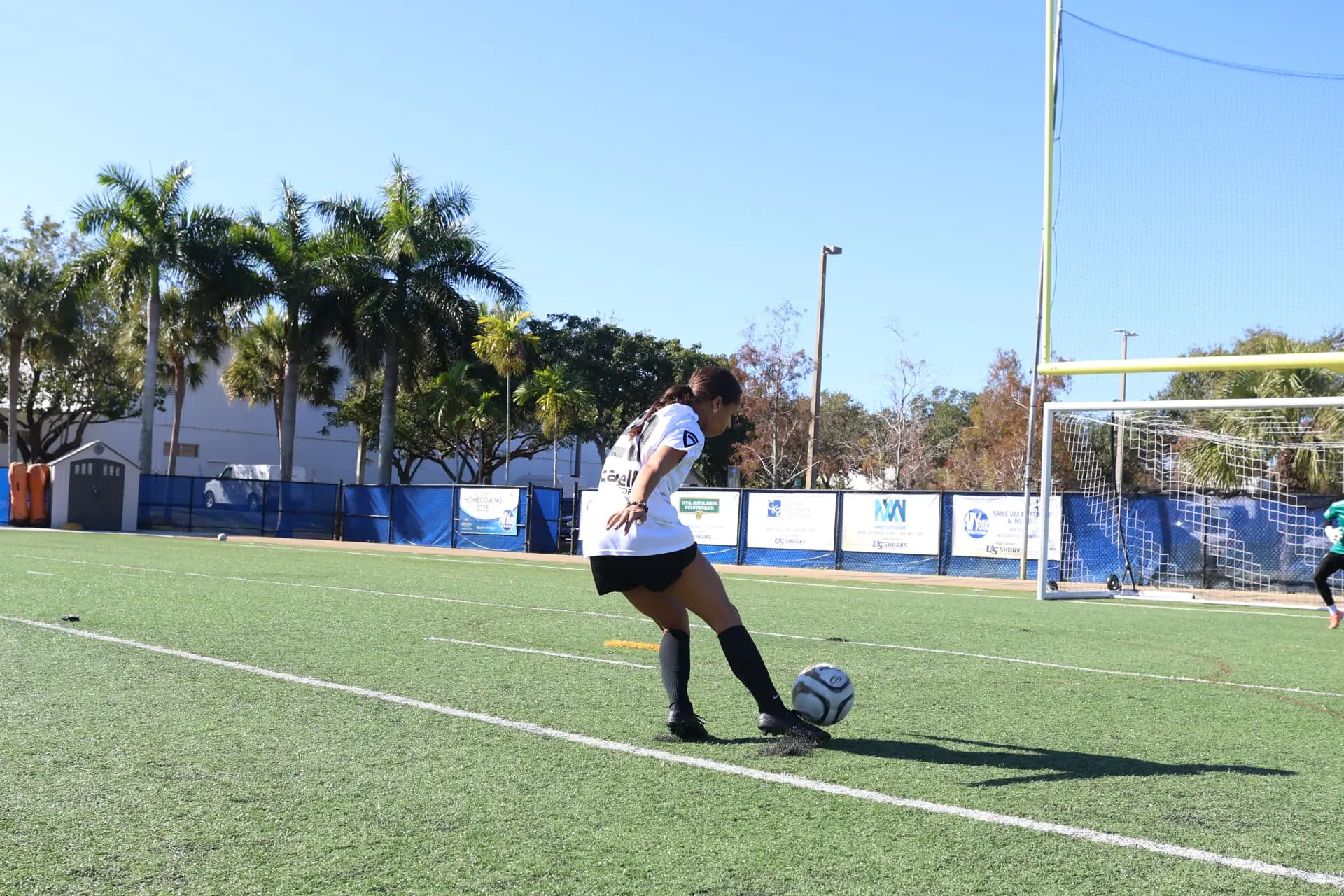 Player in white kit crossing the ball from the wing