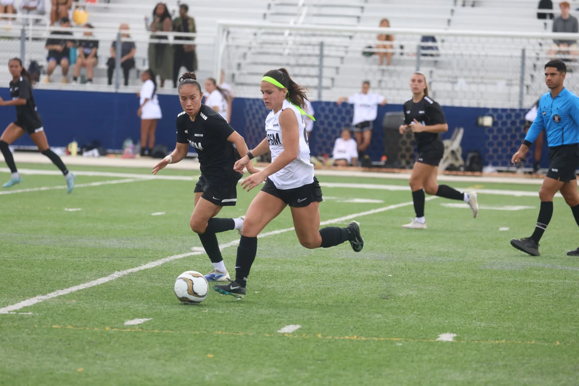 Two players competing for possession during the combine match
