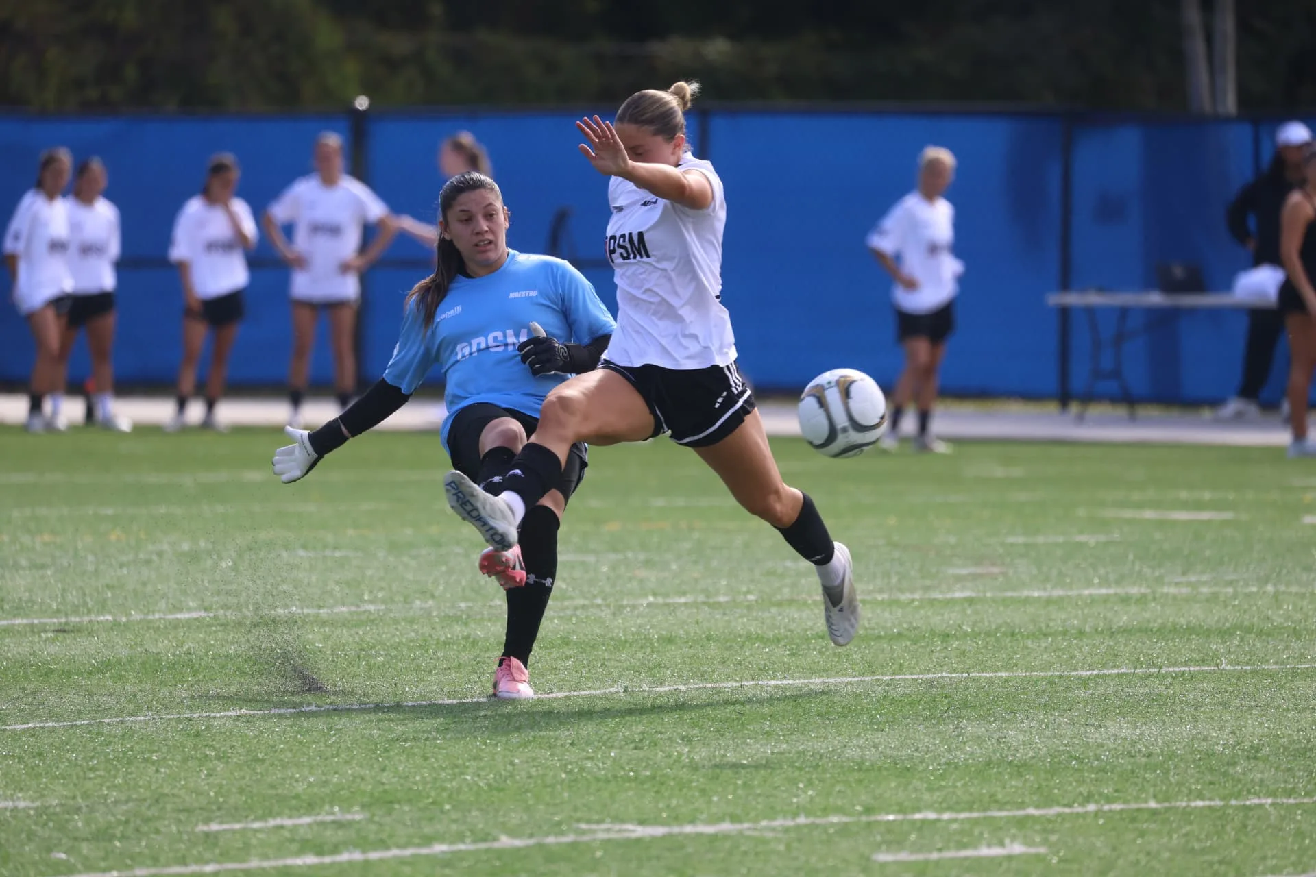 Striker firing a shot past the onrushing goalkeeper
