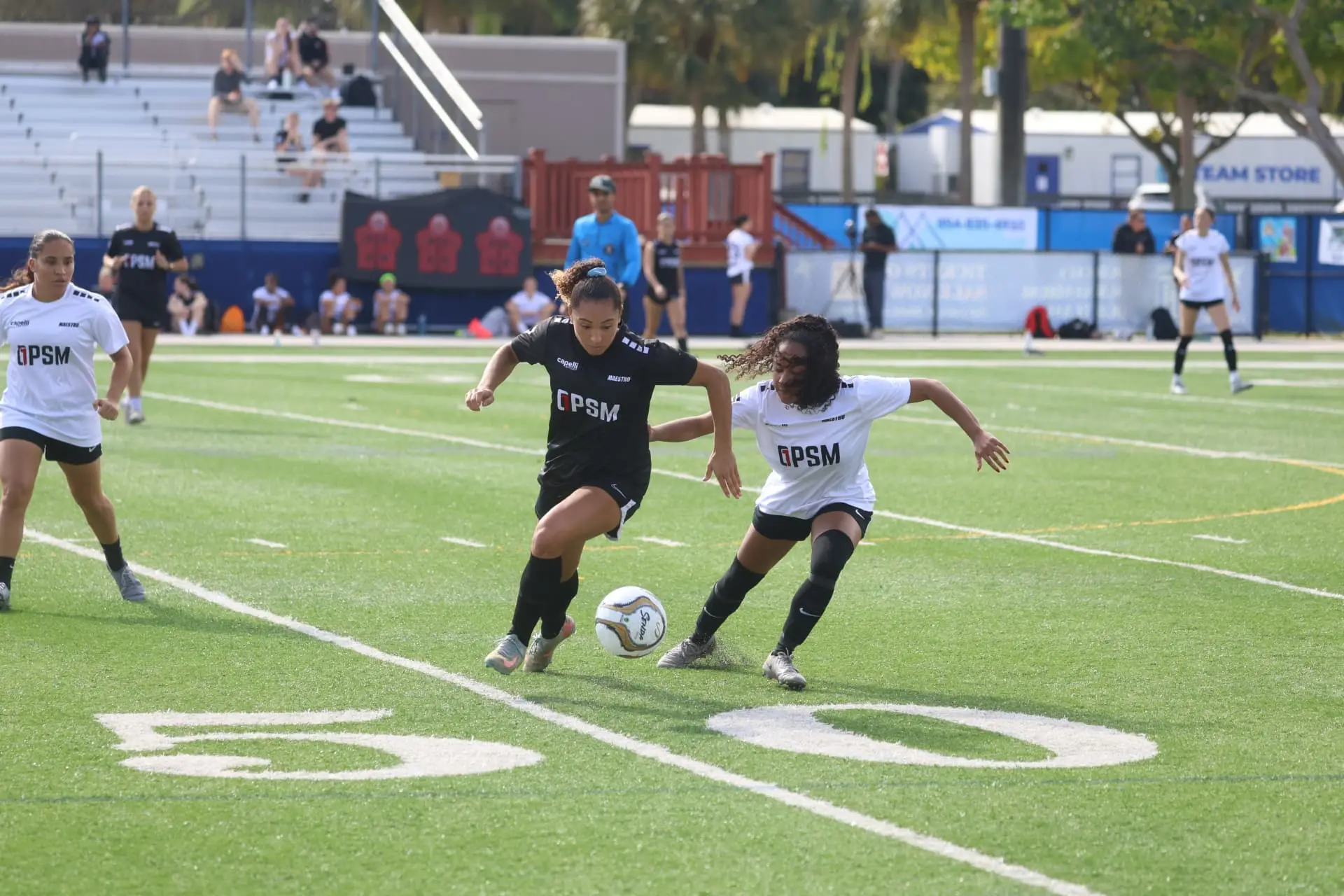 Two players duelling for the ball at midfield