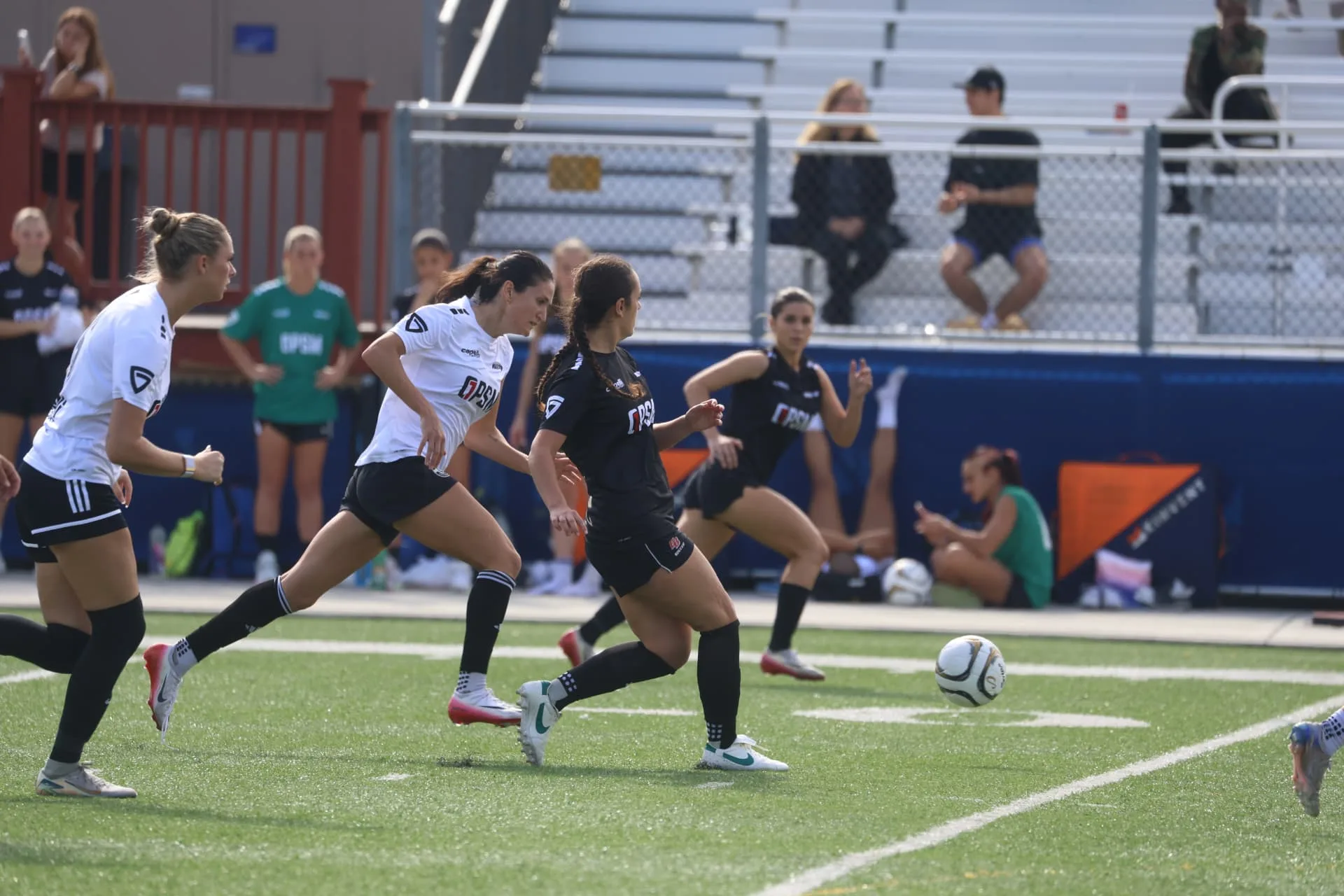 Players sprinting to chase down a loose ball