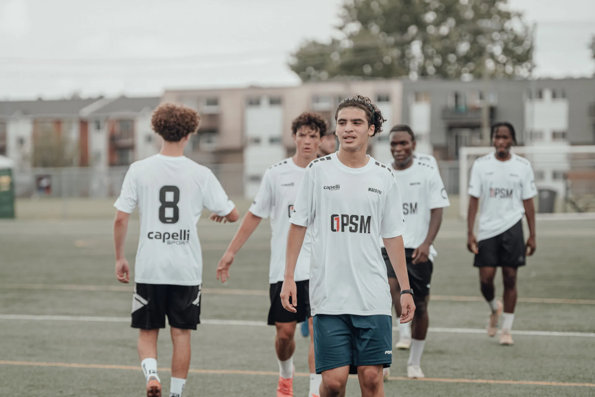 Players in white kits walking off after a match