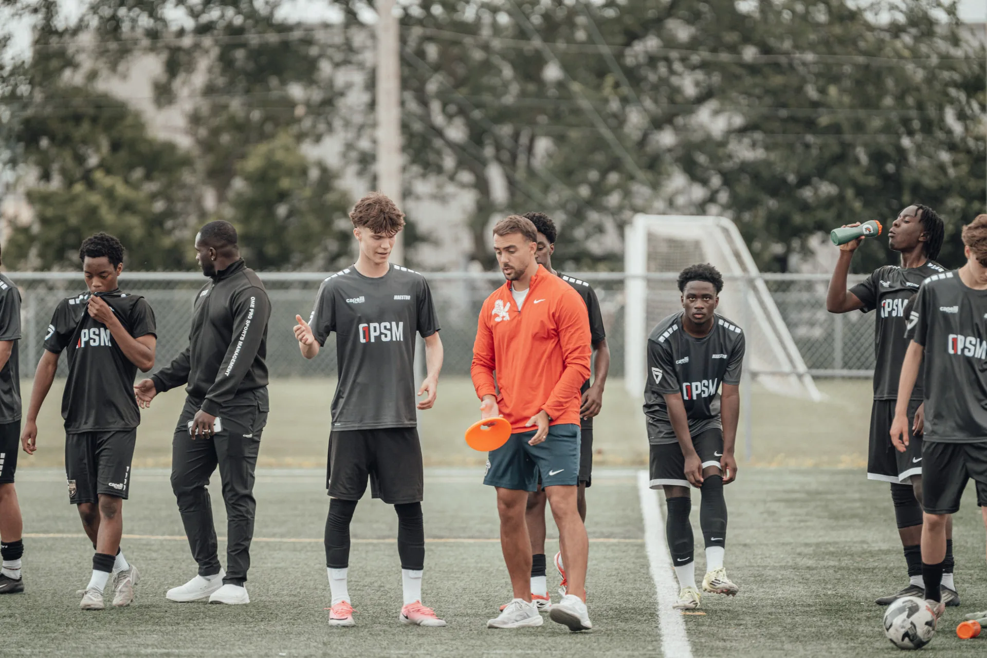 Coach briefing players during a water break