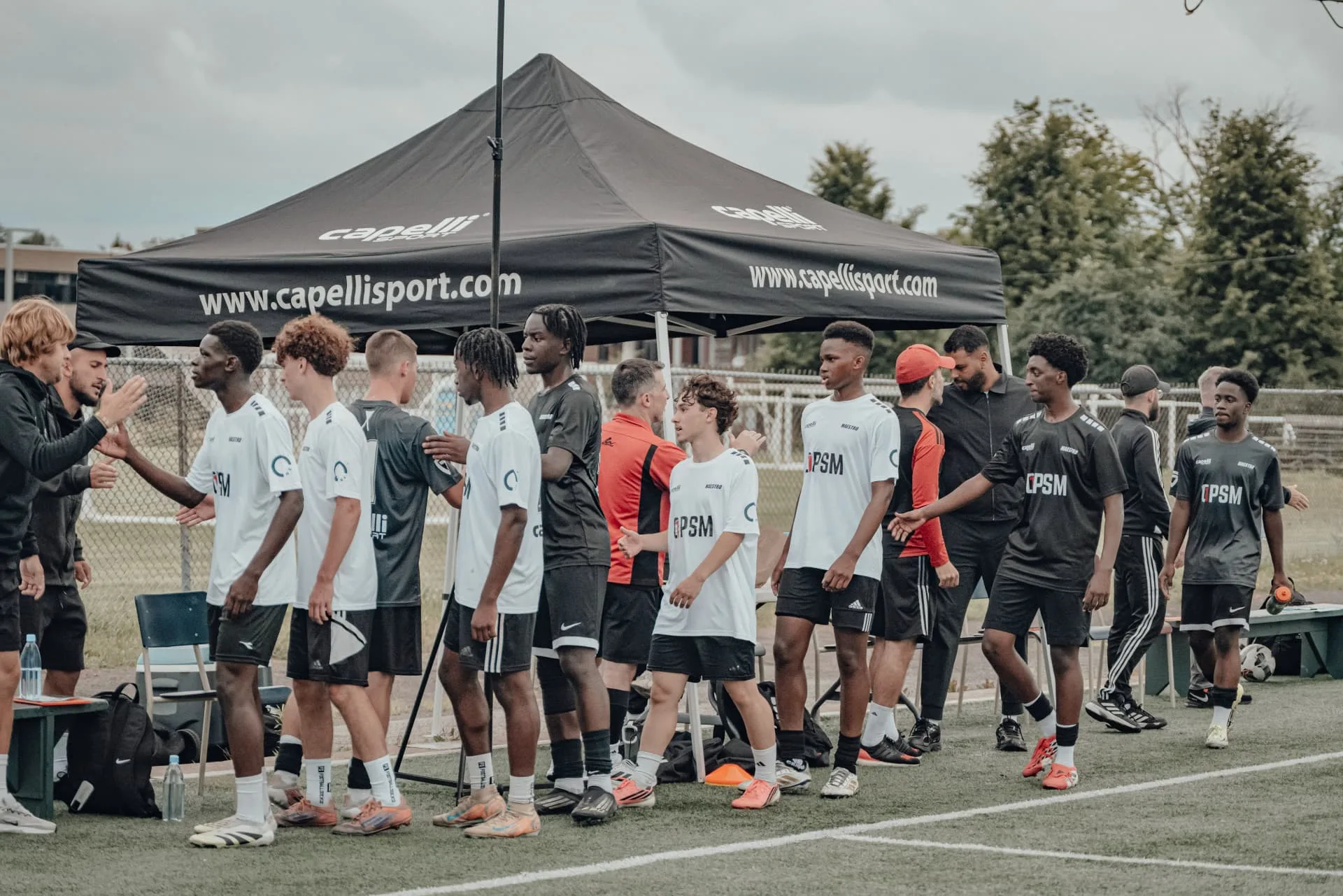 Players lining up under the tent before kickoff