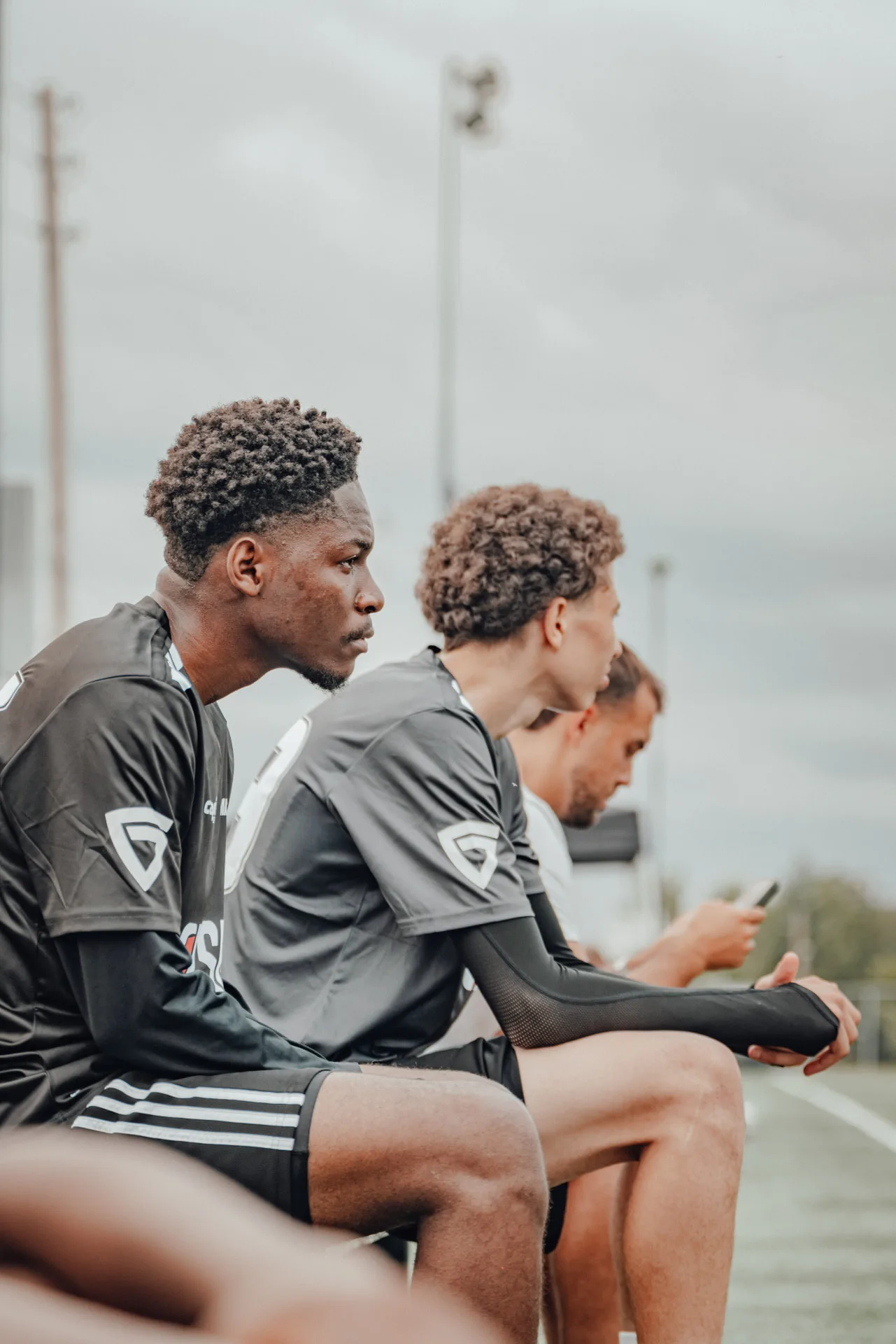 Players watching from the bench between sessions