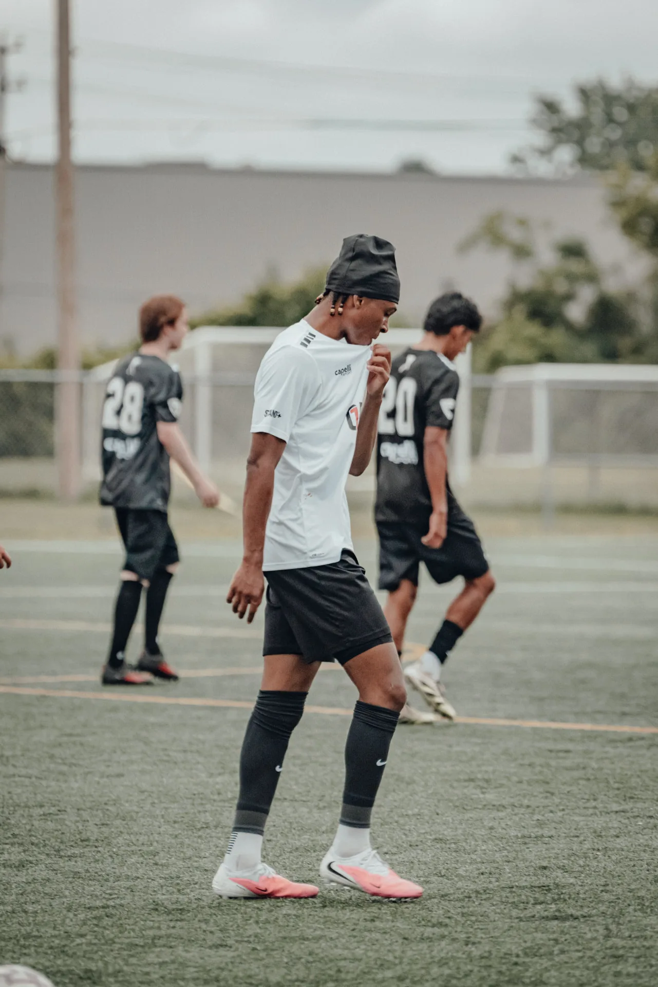 Player in white kit walking back into position
