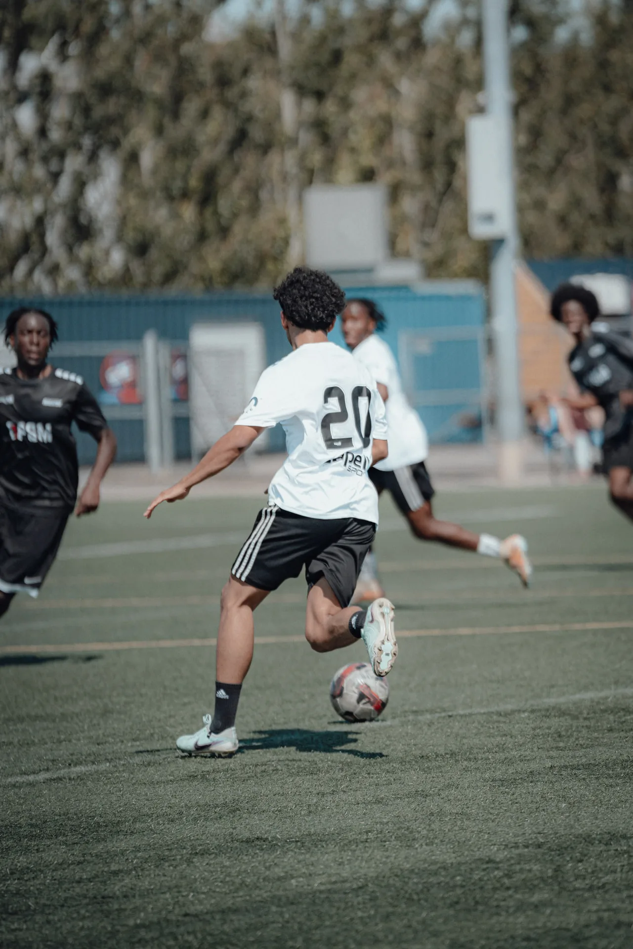 Midfielder driving forward with the ball