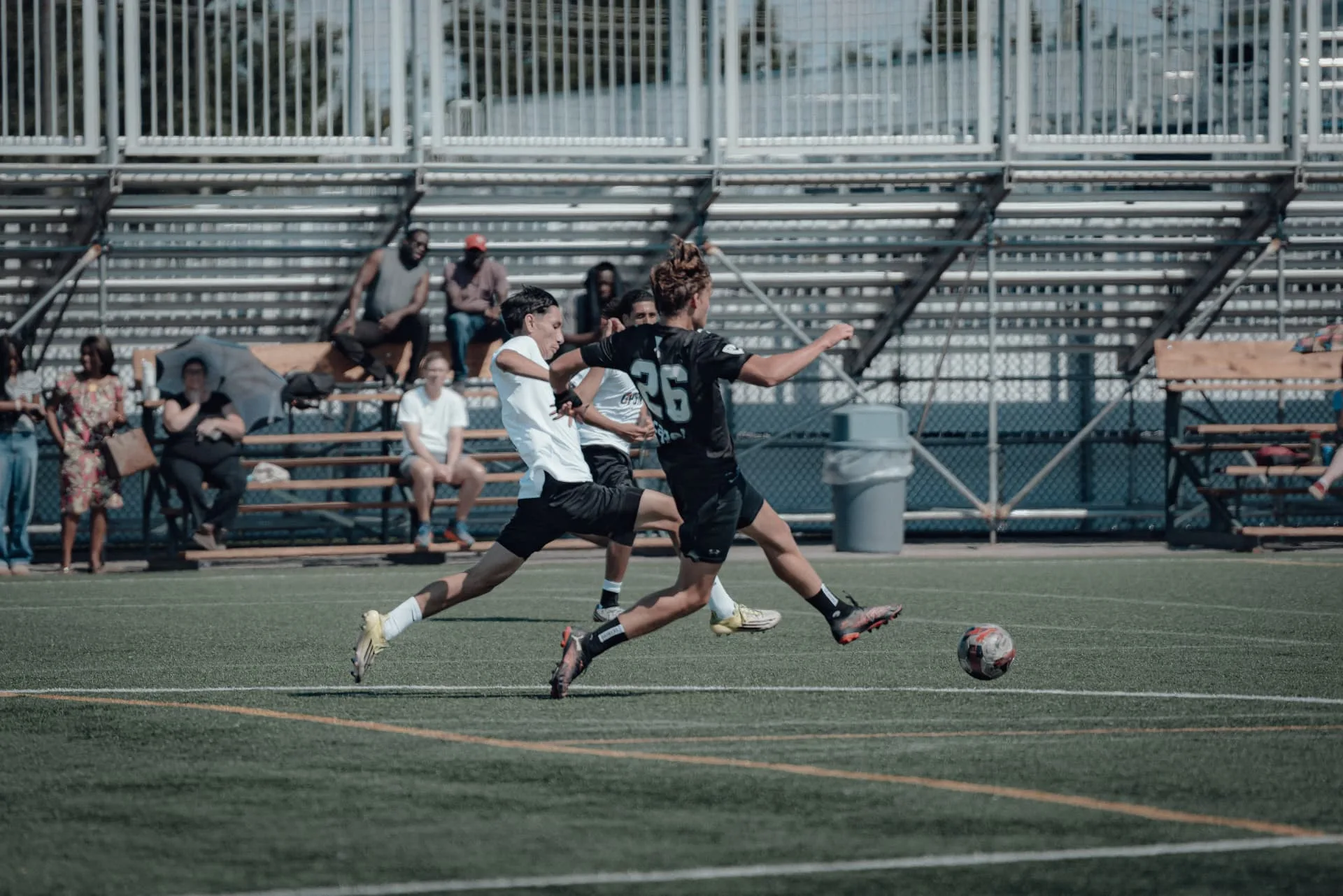 Two players sprinting to chase down the ball