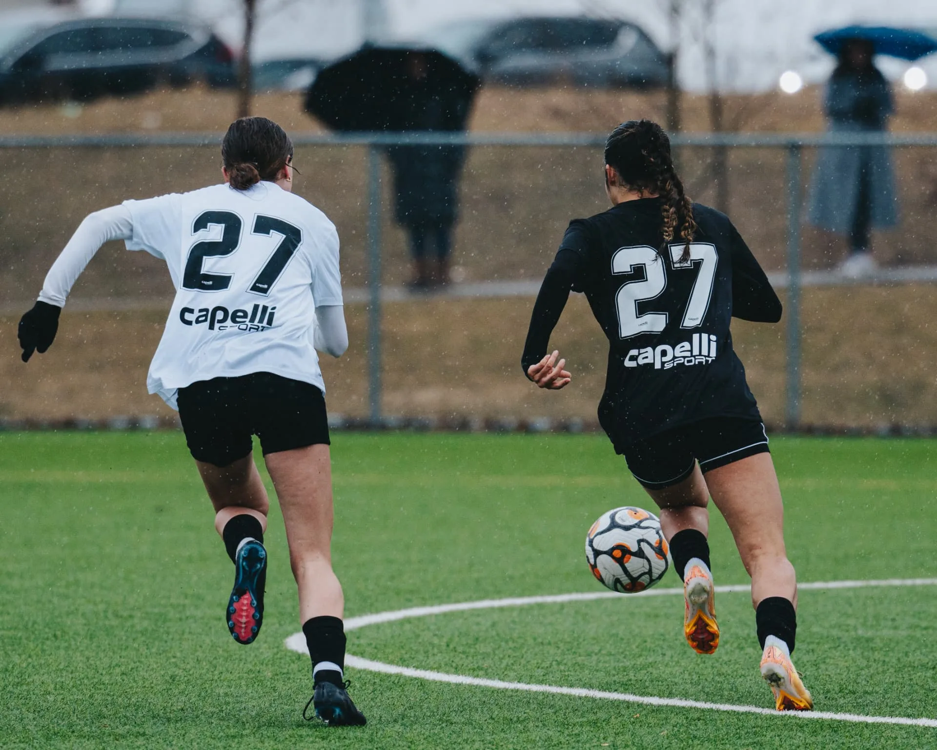 Two players sprinting down the wing in a footrace