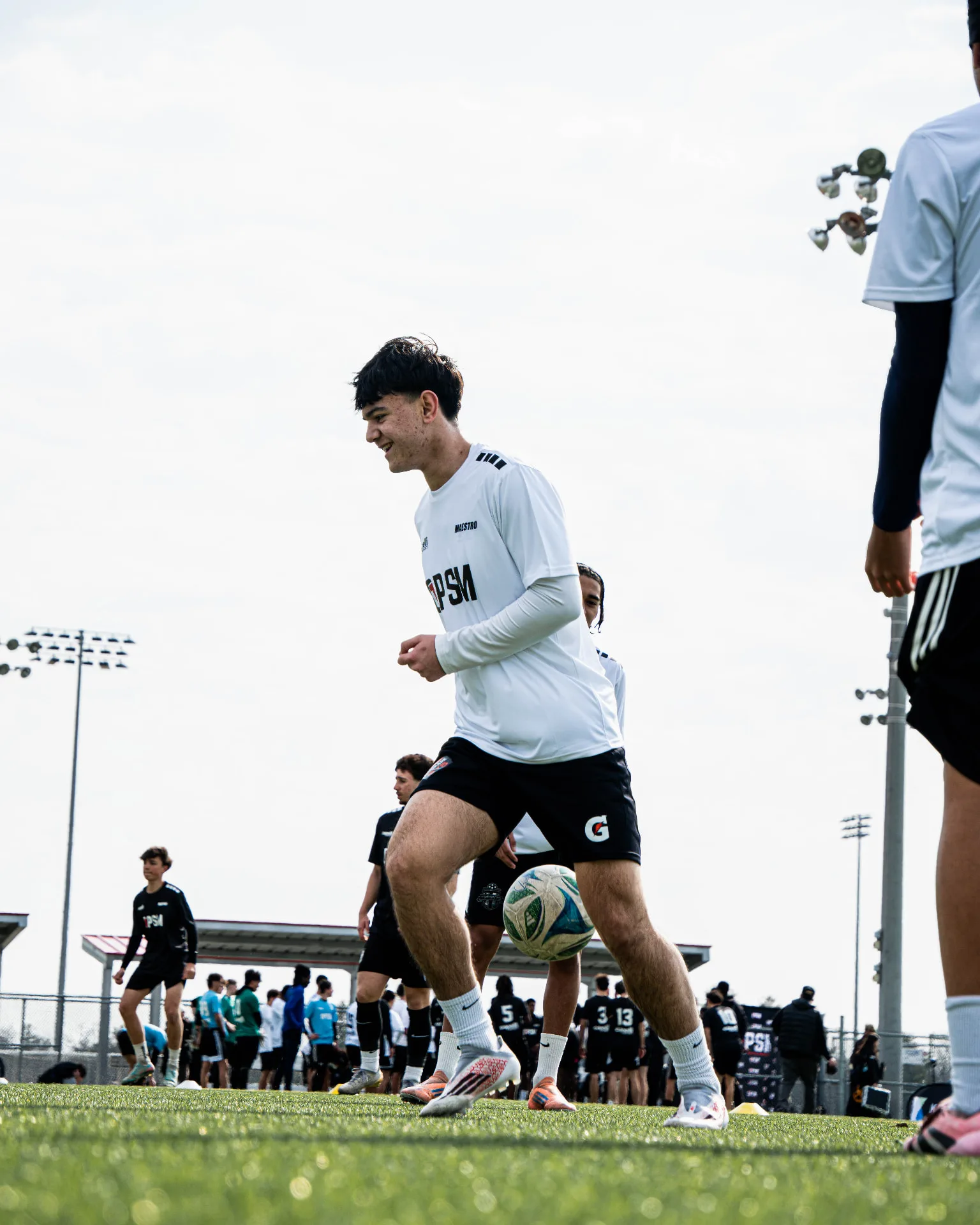 Player smiling during a warm-up rondo