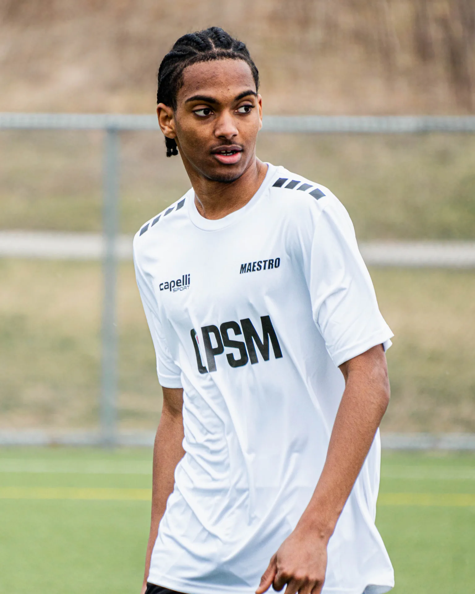 Portrait of a player in the OPSM white match kit