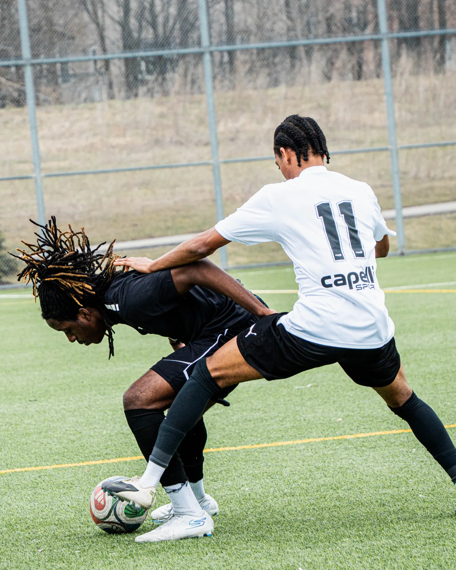 Two players shielding and pressing for possession