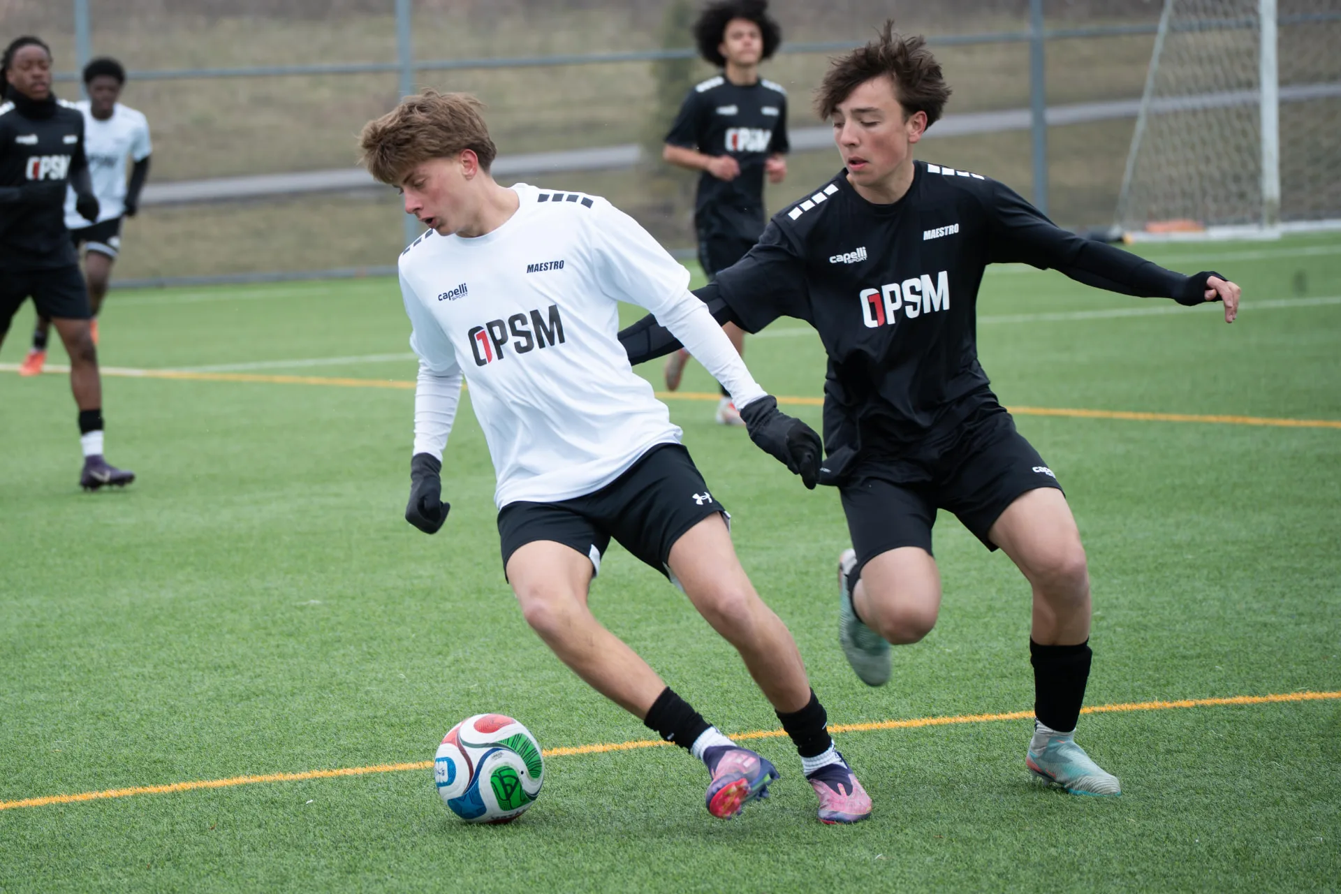 Two players duelling for possession in midfield