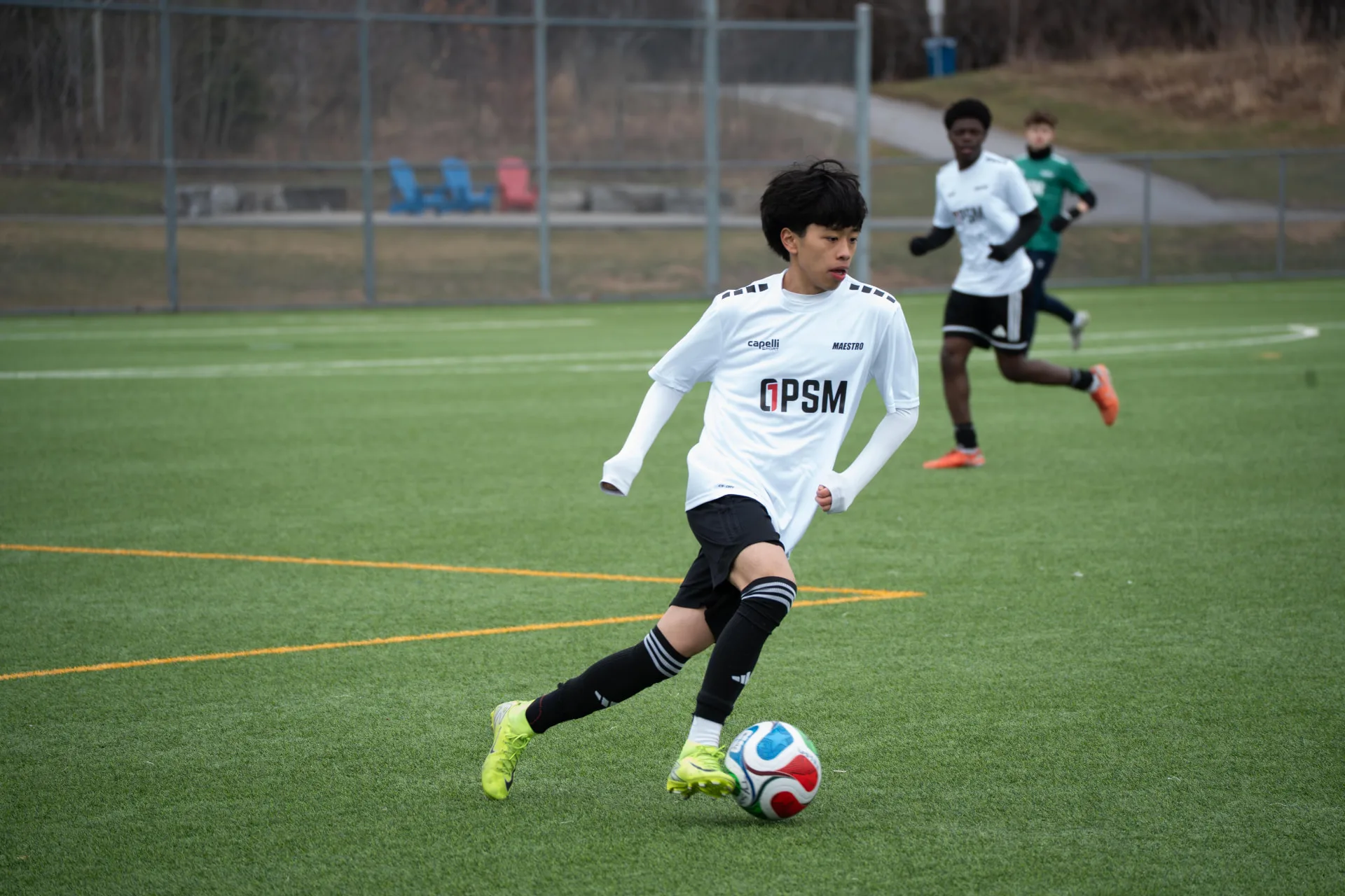 Midfielder driving forward with the ball on the wing