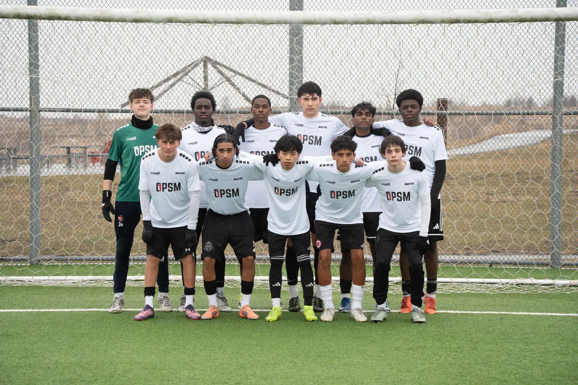 Team photo of the white squad in front of the goal